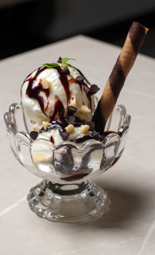 Ice Cream With Chocolate Syrup on Clear Glass Bowl
