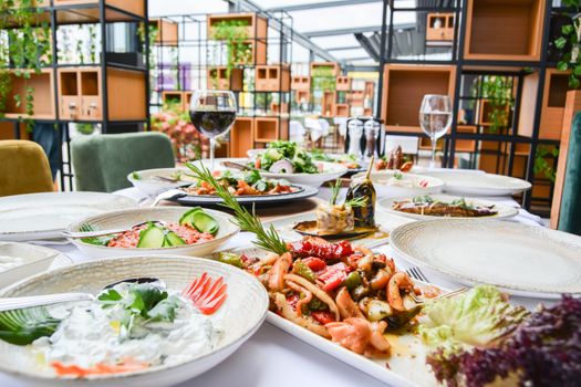 A beautifully arranged table in a restaurant showcasing gourmet dishes and fine dining ambiance.