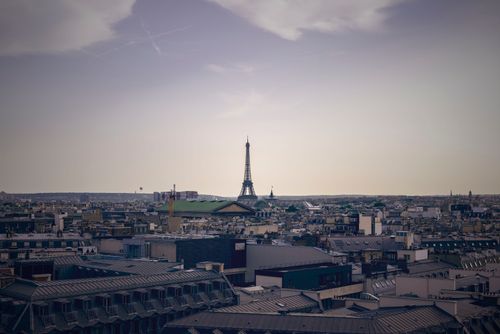 Free Distant view of Paris skyline featuring the Eiffel Tower against a clear sky. Stock Photo