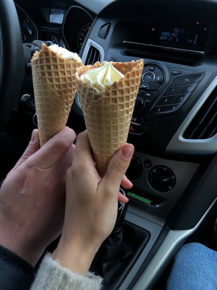 People Holding Ice Cream In Cones