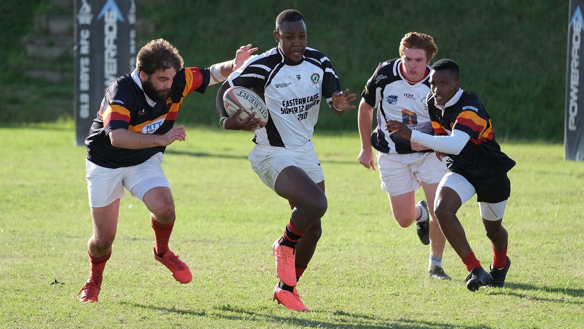 Rugby players competing fiercely during a match in South Africa, showcasing teamwork and athleticism.