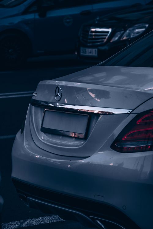 Free Close-up of a sleek Mercedes Benz car at night in Rabat, showcasing luxury and elegant design. Stock Photo