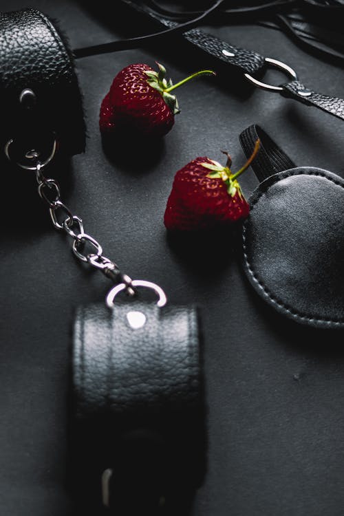 Free Two Strawberry Fruit Surrounded by Leathercrafts Stock Photo