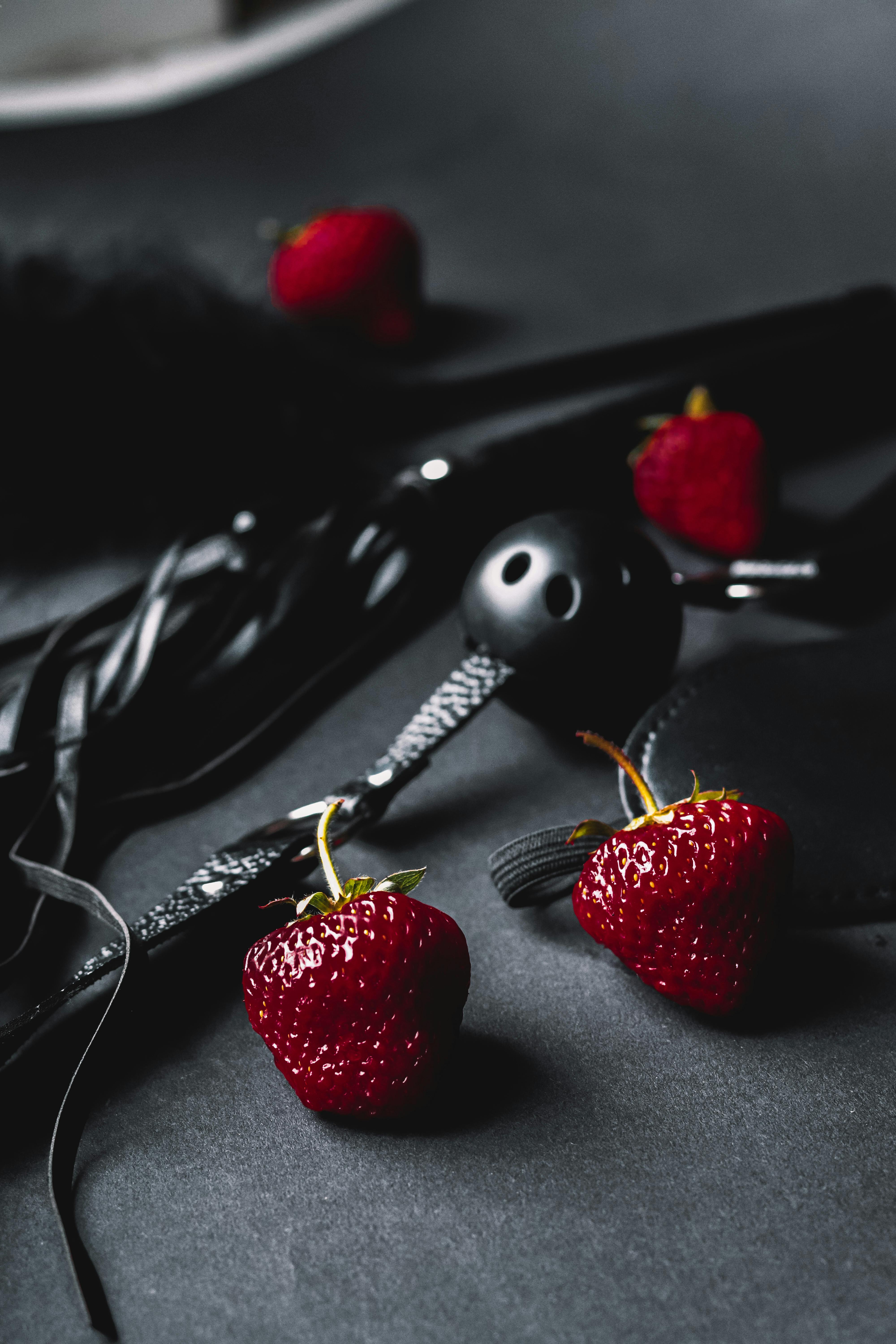 fresh strawberries and black ball gag