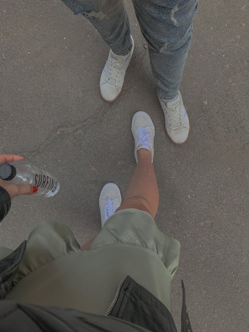 Two People Standing on Concrete