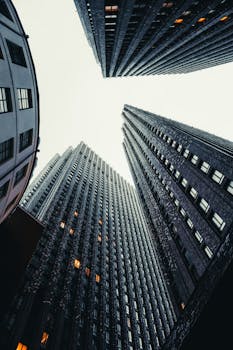 Low angle view of tall skyscrapers reaching towards the sky in a cityscape.