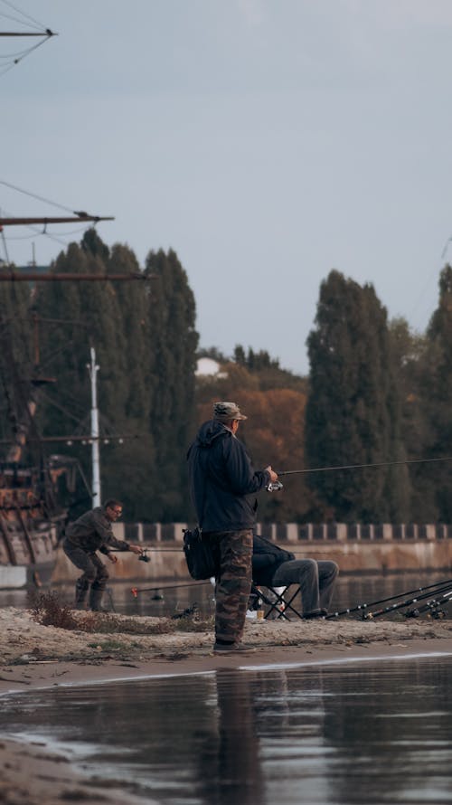 Men Fishing on Riverbank