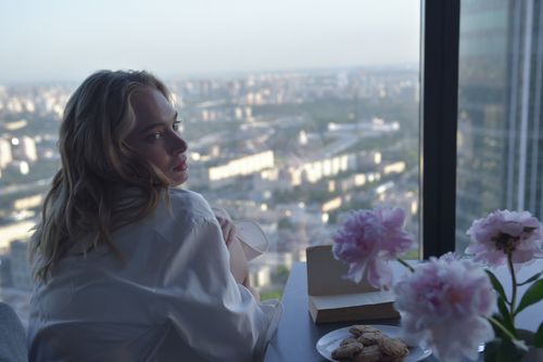 A Woman Sitting Beside the Glass Windows · Free Stock Photo