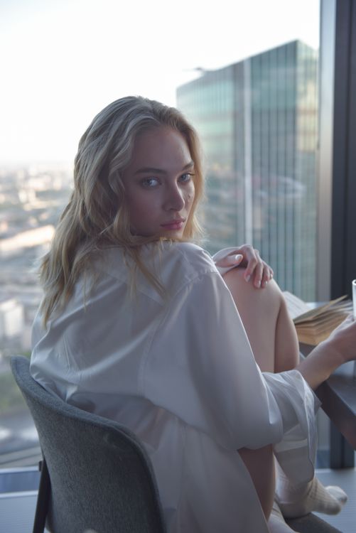 Woman in White Long Sleeve Shirt Sitting on a Chair · Free Stock Photo