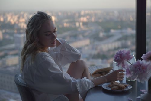 A Woman Sitting Beside the Glass Windows · Free Stock Photo