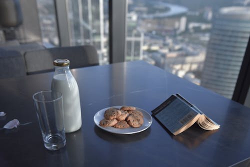 Table Near the Glass Windows with Milk and Cookies