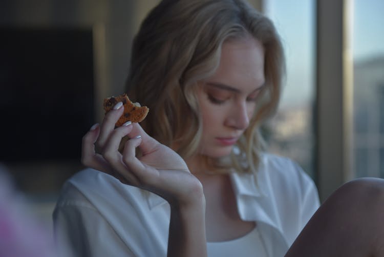 Woman In White Shirt Holding Brown Cookie