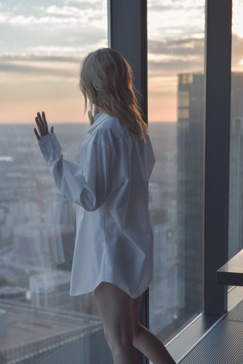 Woman in White Shirt Looking Outside the Window · Free Stock Photo