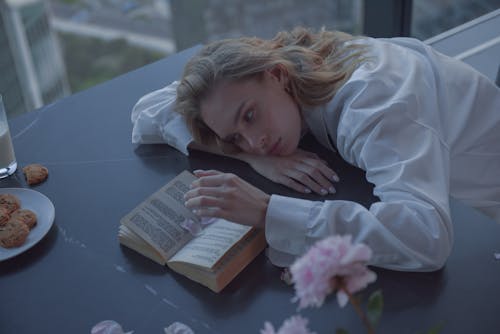 Sad Woman leaning on a Table Top