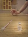 Shallow Focus of Syringe and Vaccine on Wooden Surface