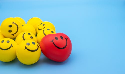 Yellow and Red Smiley Emoticon on Blue Surface