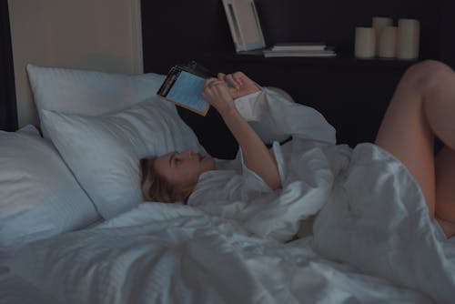 Free Sexy Woman Reading a Book in the the Bed Stock Photo