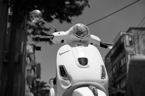 Free Grayscale Photo of a Vespa Scooter Stock Photo