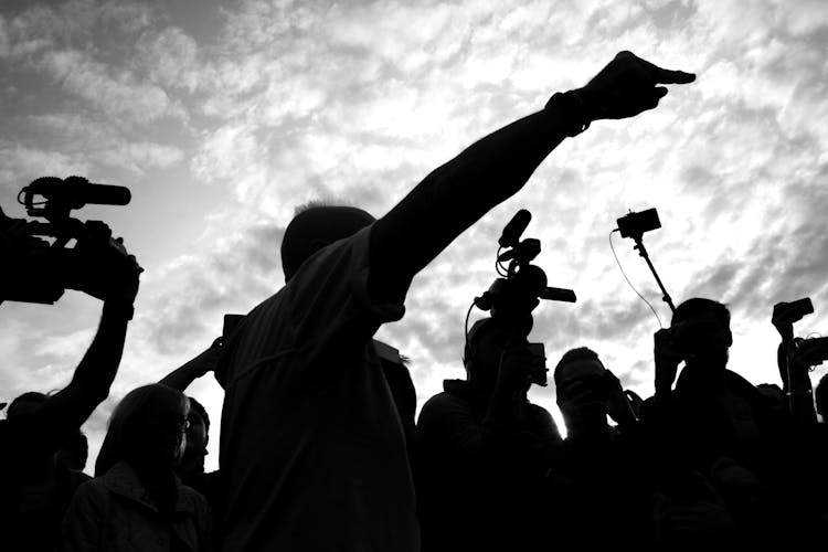 Silhouette Of People Video Recording On The Street