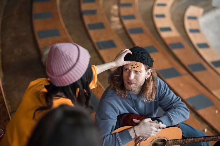 Woman Putting Card On Man Head