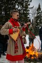 A Man in Traditional Wear Playing the Balalaika During the Maslenita Festival