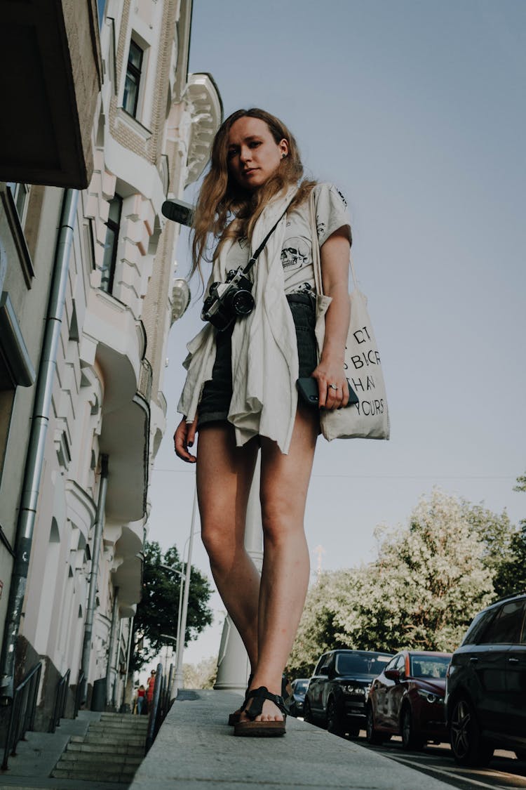 A Woman Standing On A Concrete Ledge Near The Stairs