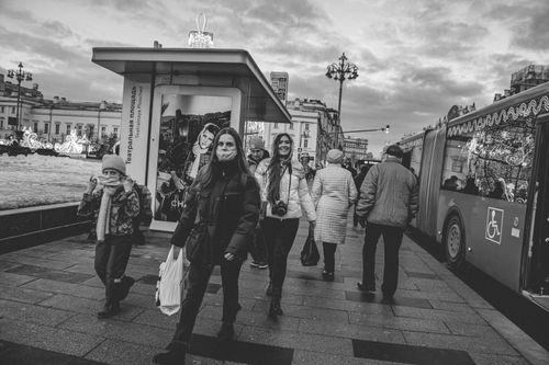 Free Black and white photo of people walking on a Moscow street in winter, captures urban life. Stock Photo