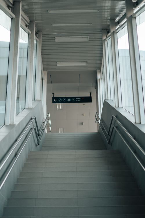 Free Modern indoor staircase with glass and metal elements, low angle view. Stock Photo