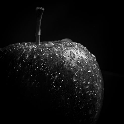 Free Close-up shot of an apple with water droplets in grayscale, emphasizing texture and freshness. Stock Photo