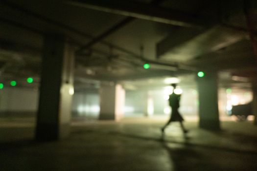 Defocused Picture of a Person in an Underground Car Park
