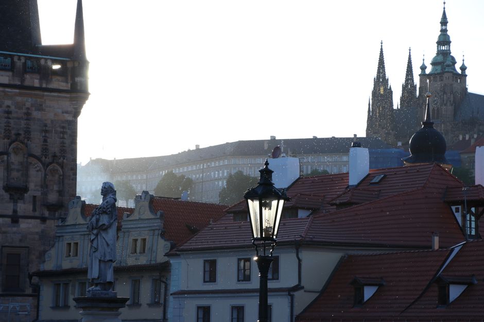 Beautiful dusk scenery of Prague's iconic rooftops and Gothic architecture, capturing the city's timeless charm.