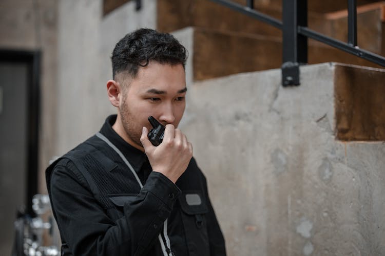 A Man Talking On A Walkie Talkie 