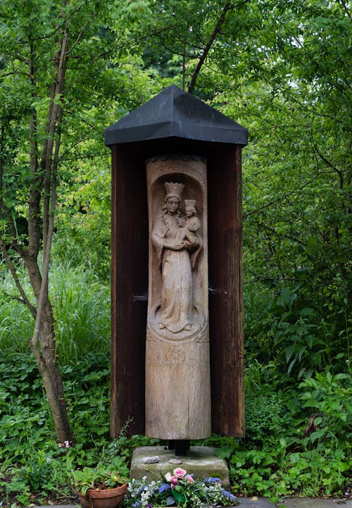 Brown Wooden Statue Near the Green Trees