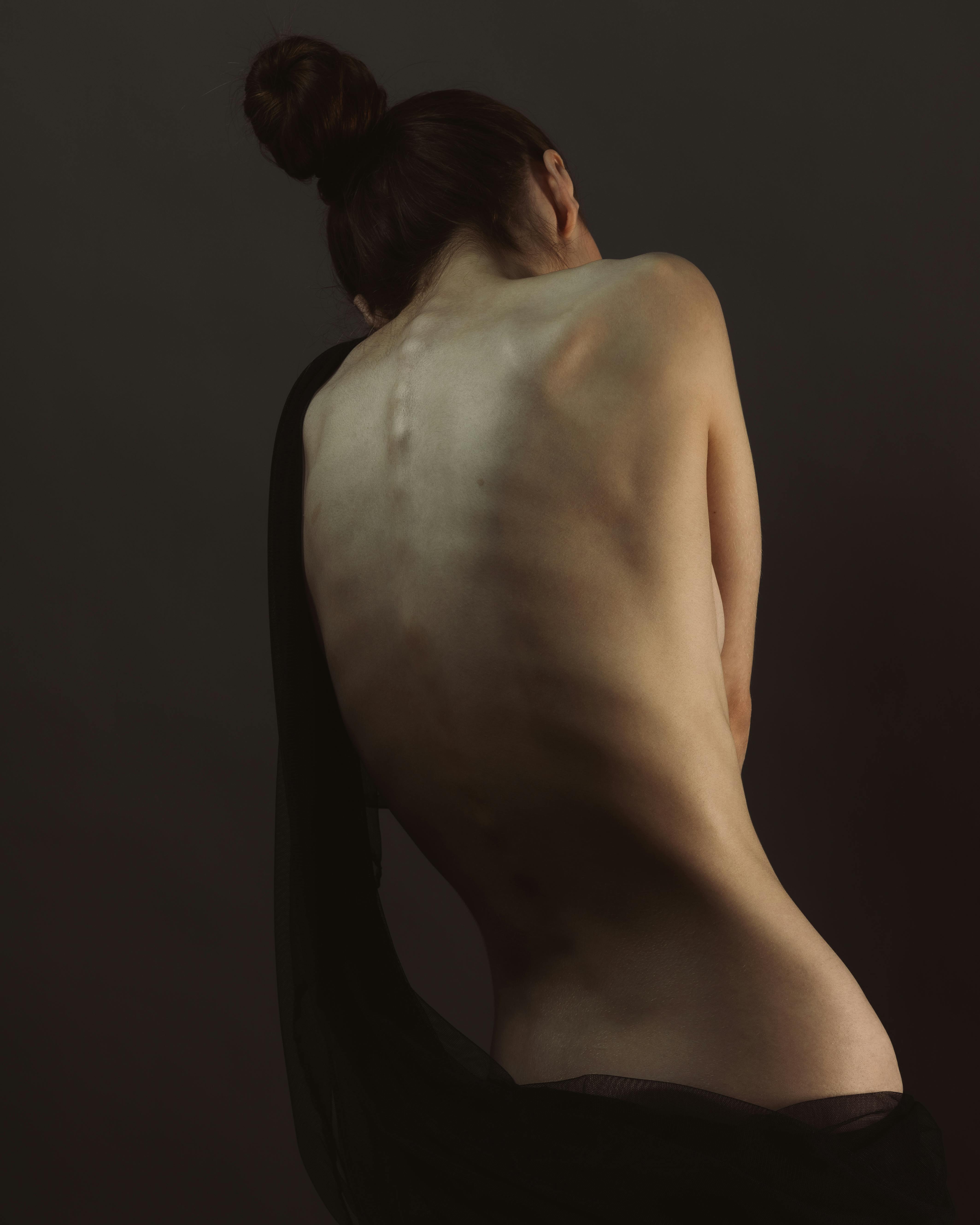 photo of a topless woman s back