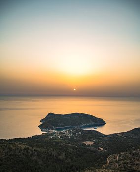 Breathtaking view of a serene island sunset over Asos, Greece, showcasing tranquility and natural beauty.