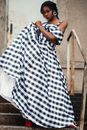 Photo of a Woman Wearing Gingham Dress