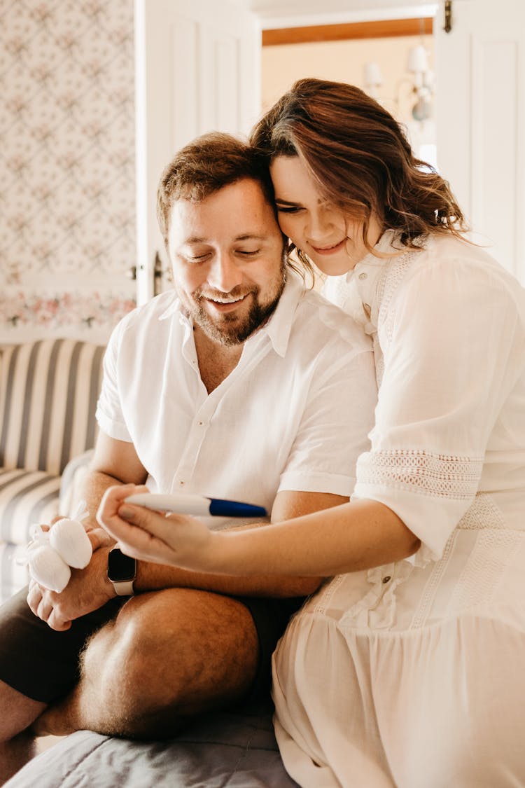 Happy Couple Looking At Pregnancy Test Together