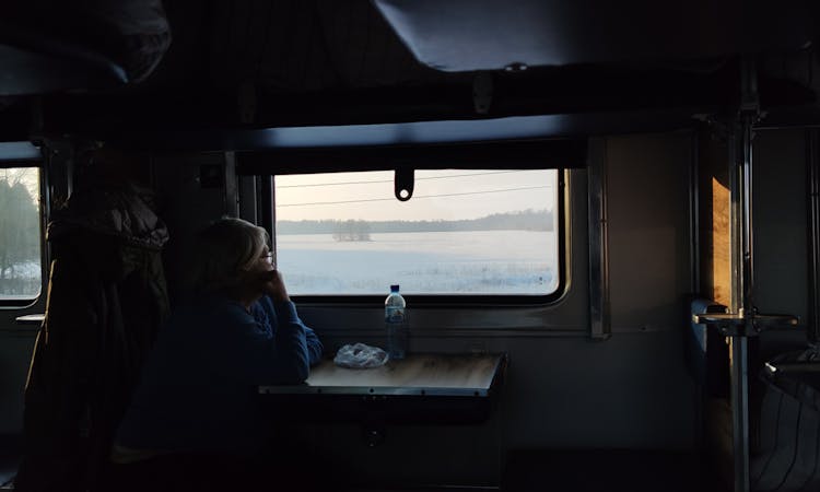 Person Inside A Train Looking Outside The Window