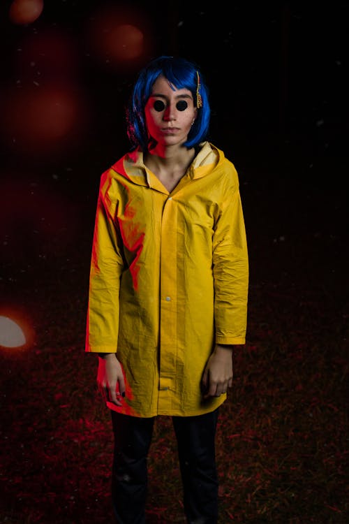 Woman in Yellow Jacket and Blue Hair Standing