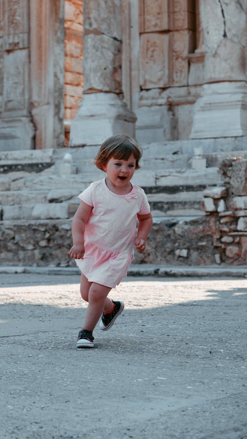 Free Photo of a Kid in a Pink Dress Running Stock Photo