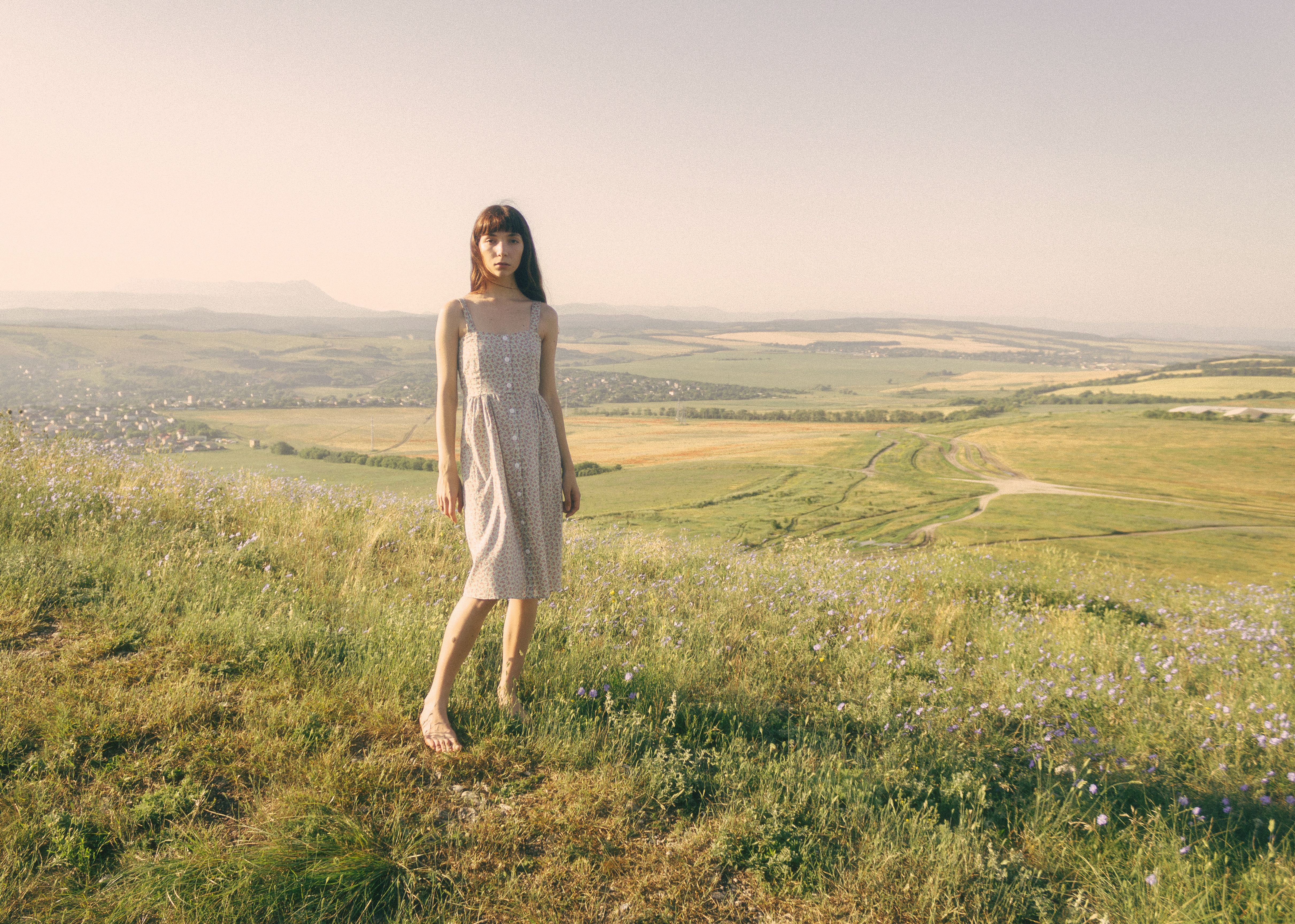 Beautiful Woman in a Dress Standing on Grass Field · Free Stock Photo