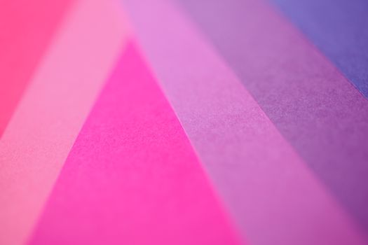 Vibrant close-up of overlapping pastel paper in pink shades, creating an abstract pattern.