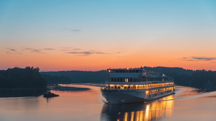 Ferry Boat Cruising On River During Dusk 