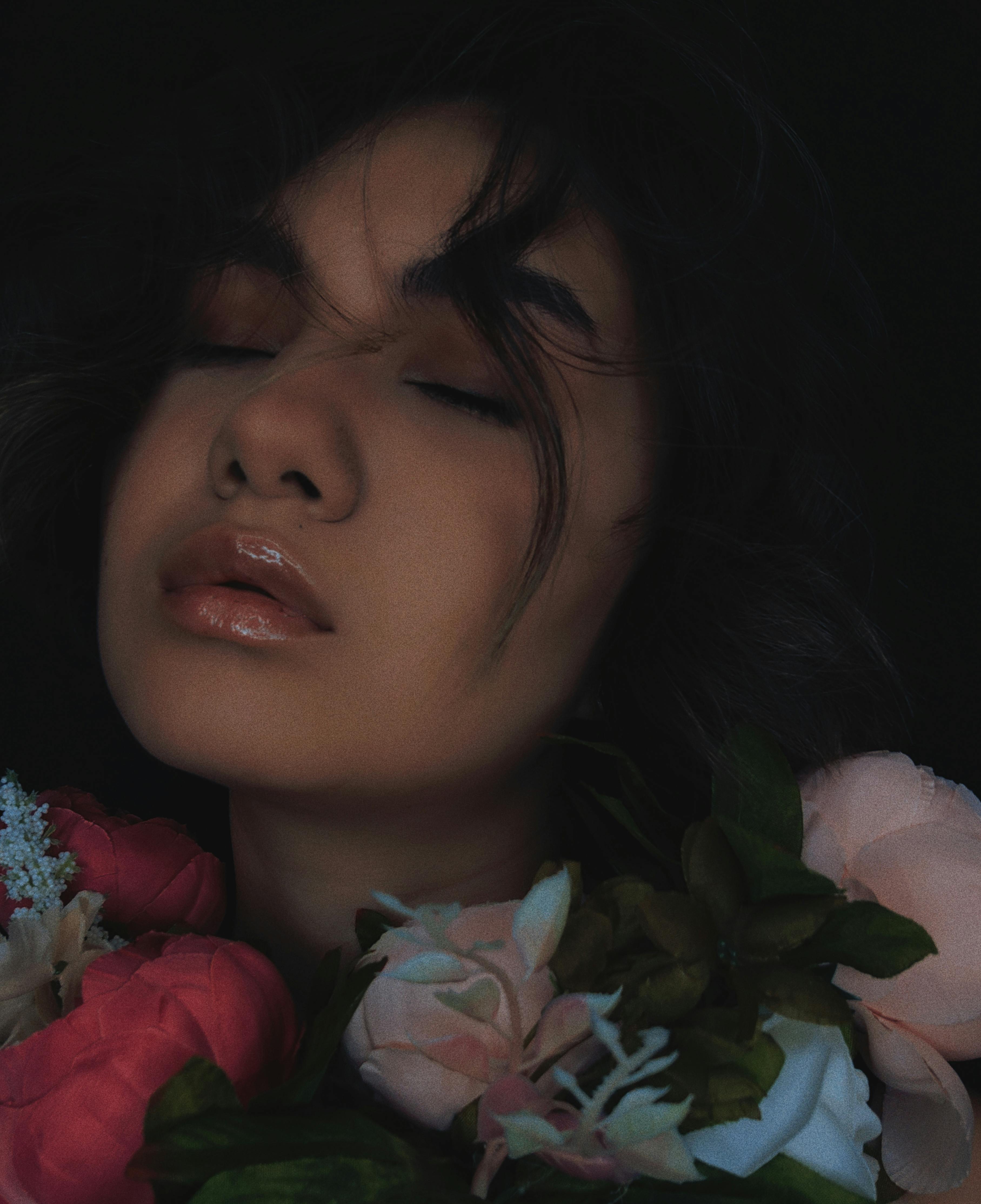 Woman in Red Shirt Holding Bouquet of Flowers