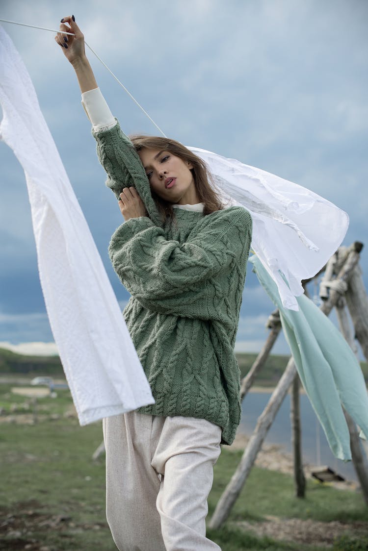 A Woman Holding The Clothes Line