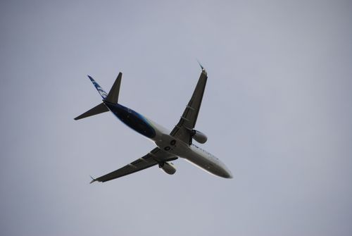 Free Commercial aircraft flying overhead with clear sky background in San Antonio. Captured from below. Stock Photo