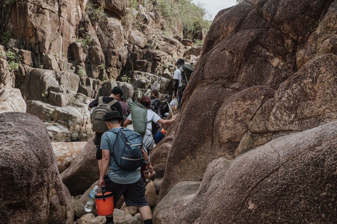 People Walking Between Boulders · Free Stock Photo