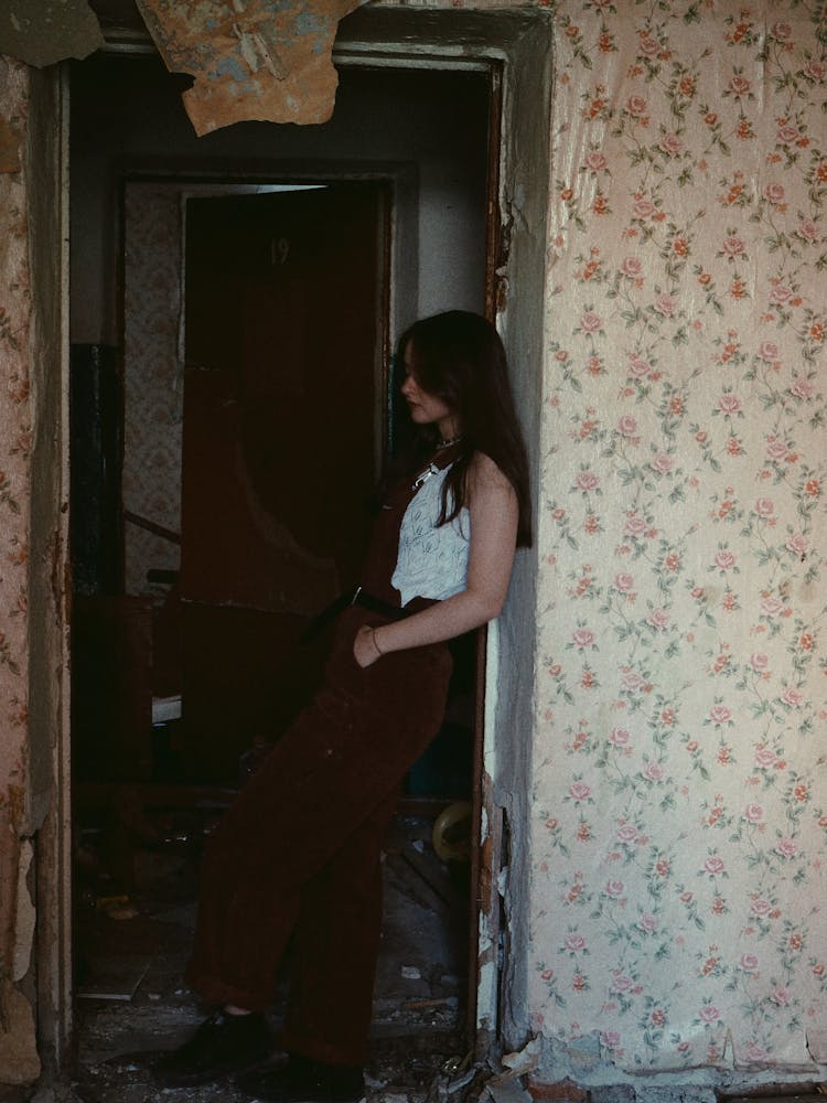 Woman Standing In Doorway Of Abandoned House