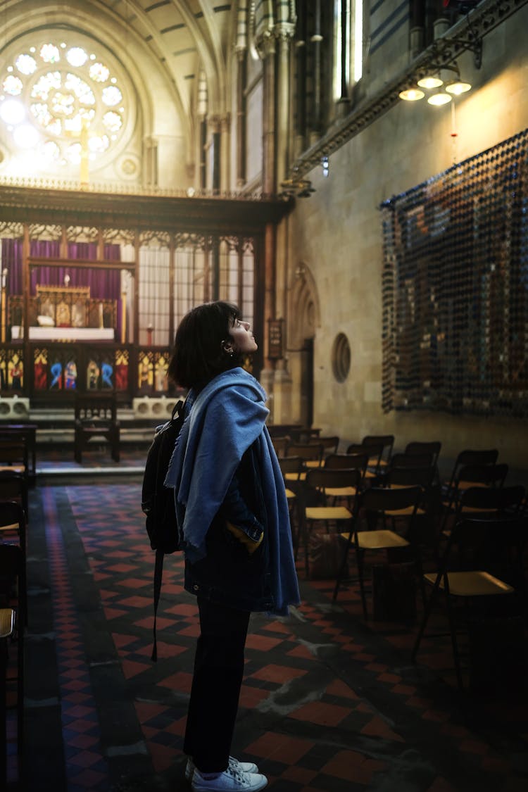 Woman In Trendy Oversize Shirt In Gothic Church