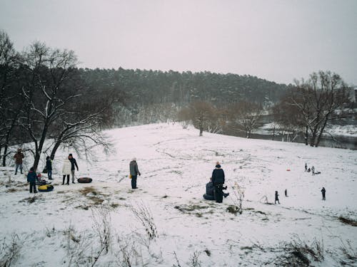 People Sitting on Snow Covered Ground